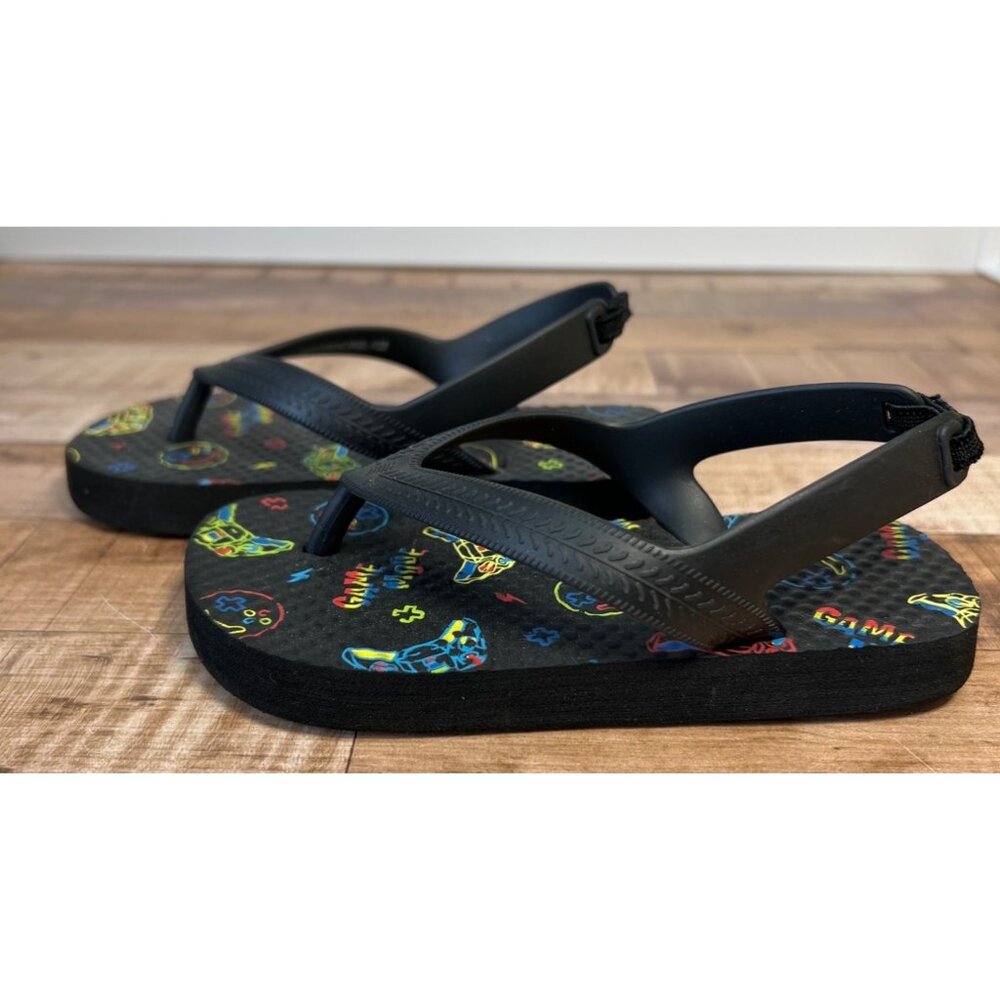 Kids Size 9 Black Flip Flops With Colorful Game Icons & Text Design